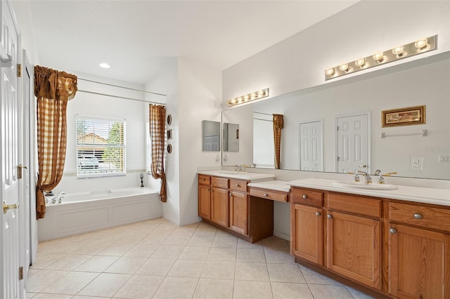 bathroom with a tub to relax in, tile patterned flooring, and vanity