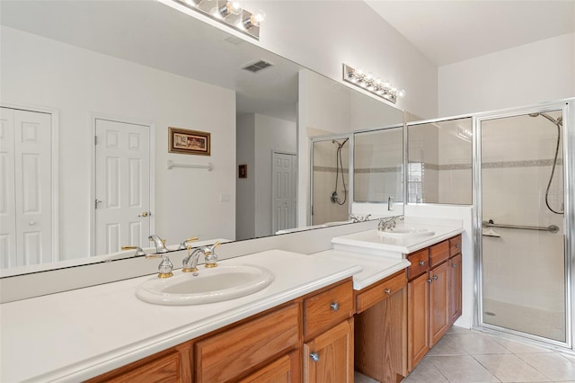 bathroom with vanity, an enclosed shower, and tile patterned flooring