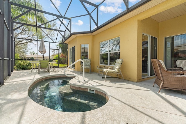 view of pool featuring a lanai, a jacuzzi, and a patio area