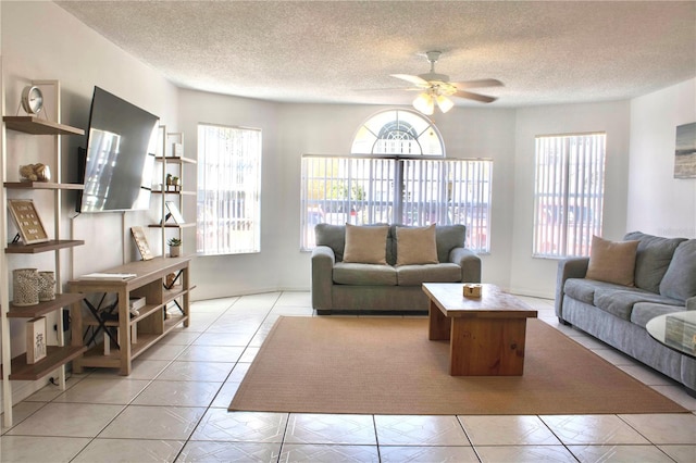 living room with light tile patterned floors, a textured ceiling, and ceiling fan