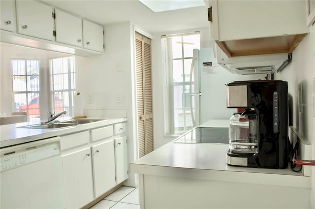 kitchen featuring sink, a wealth of natural light, white cabinets, and white dishwasher