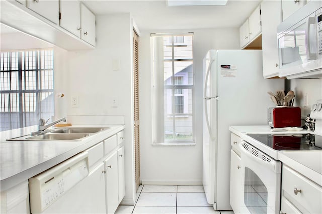 kitchen with white cabinetry, sink, white appliances, and a healthy amount of sunlight