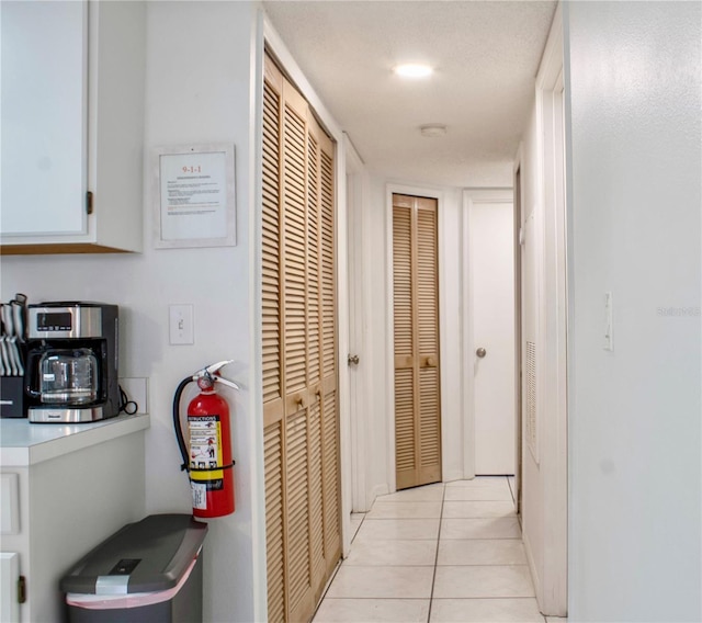 hallway with light tile patterned flooring