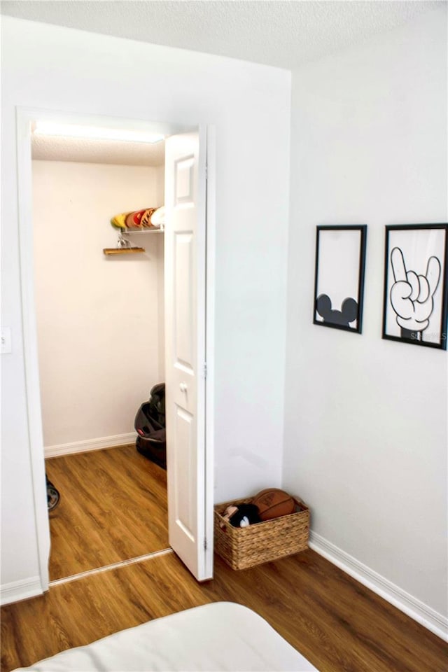 bedroom with wood-type flooring and a textured ceiling