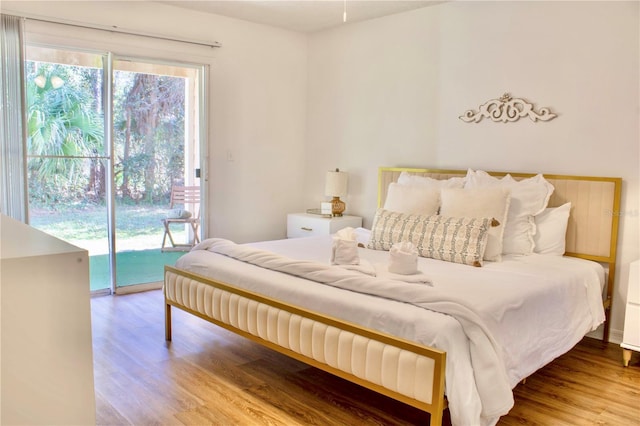 bedroom featuring access to exterior and wood-type flooring