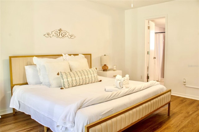 bedroom with wood-type flooring