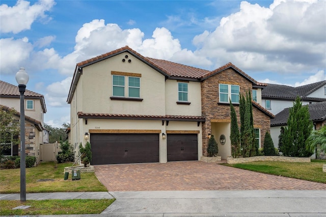 mediterranean / spanish-style home with a garage and a front lawn