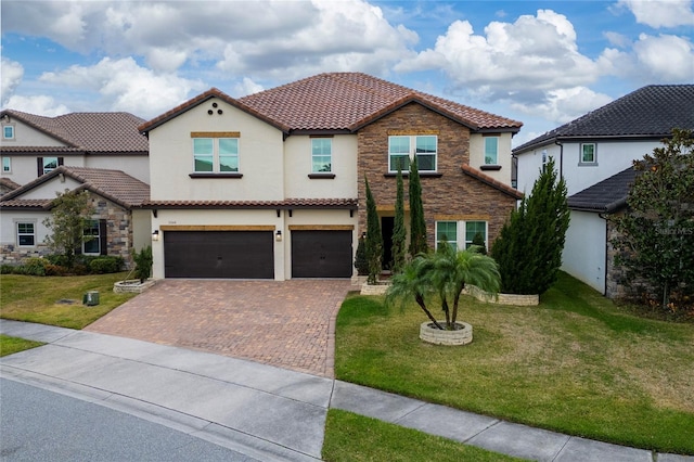 mediterranean / spanish-style house featuring a garage and a front yard