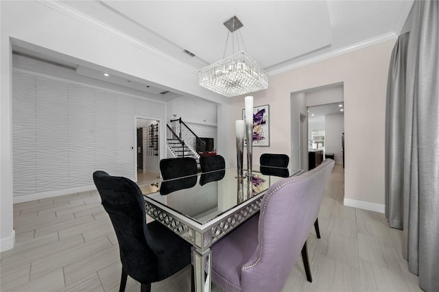 dining space with ornamental molding and a chandelier