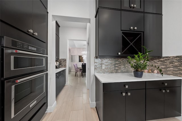 kitchen featuring backsplash and double wall oven