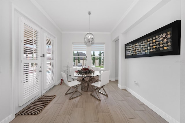 dining room with an inviting chandelier and ornamental molding