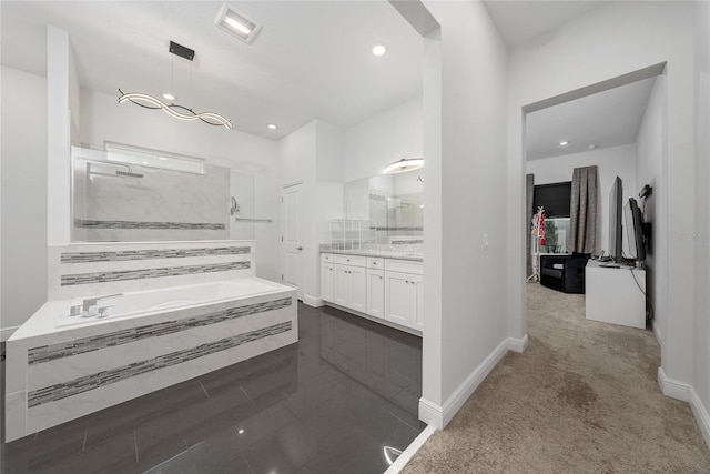 bathroom with vanity and independent shower and bath