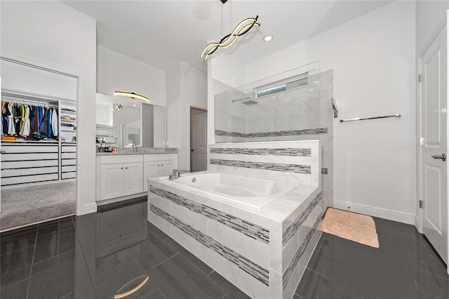 bathroom with independent shower and bath, vanity, and tile patterned flooring