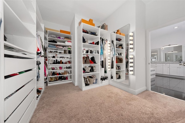 walk in closet featuring light colored carpet