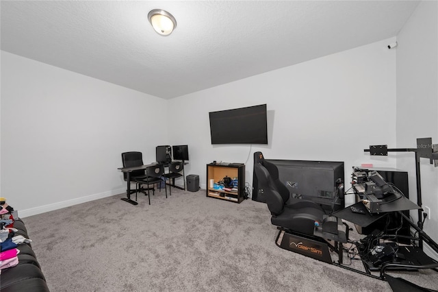 carpeted office space featuring a textured ceiling