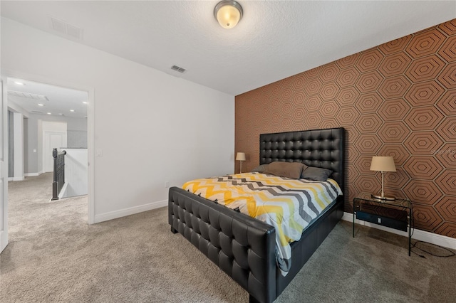 carpeted bedroom featuring a textured ceiling