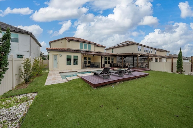 back of property featuring a swimming pool side deck, a yard, and a patio