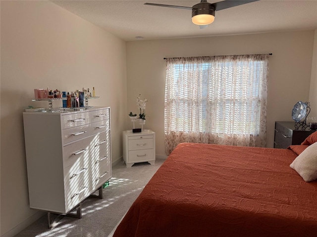 bedroom with light carpet and ceiling fan