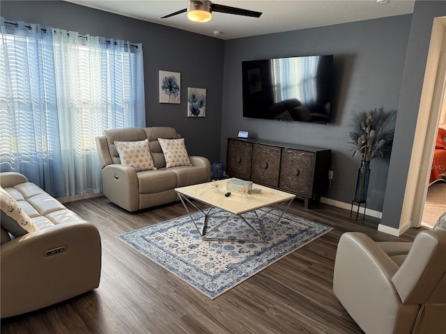 living room with hardwood / wood-style floors and ceiling fan