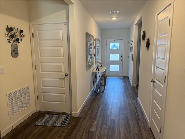 doorway to outside featuring dark wood-type flooring