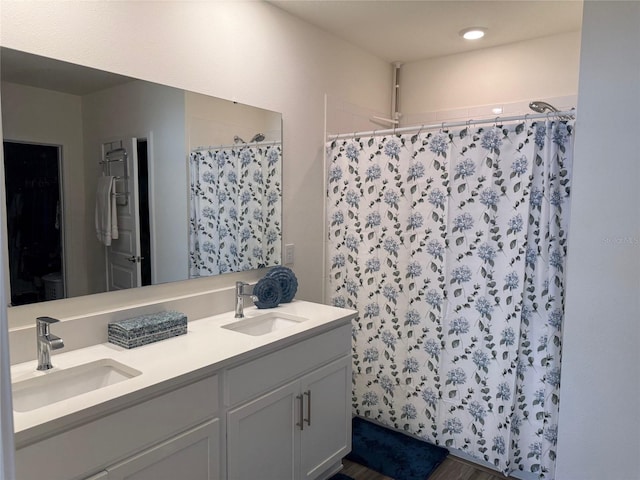 bathroom with vanity and curtained shower