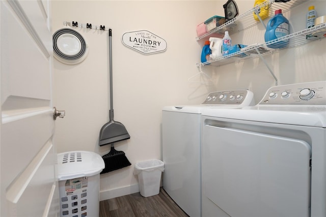 clothes washing area with laundry area, washer and clothes dryer, wood finished floors, and baseboards