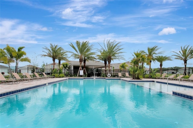 community pool featuring fence and a patio