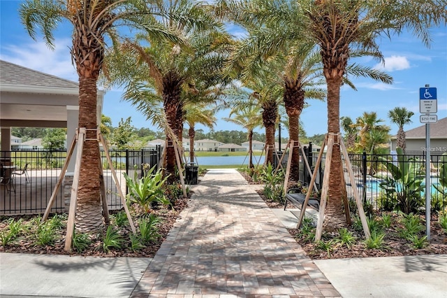 view of home's community featuring fence