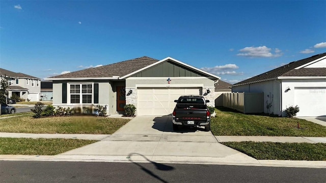 single story home with a garage, fence, driveway, board and batten siding, and a front yard