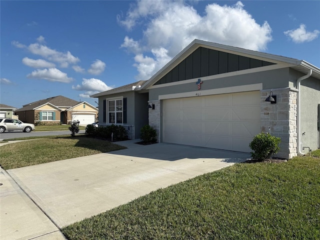 ranch-style home featuring a garage, concrete driveway, stone siding, board and batten siding, and a front yard