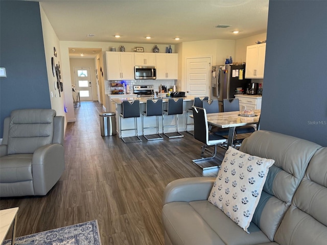 living room featuring dark wood-style floors and recessed lighting