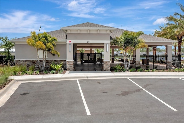 view of property with uncovered parking and fence