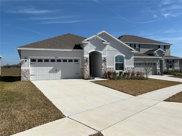 view of front of property with a garage and a front lawn