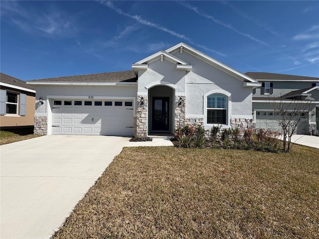 view of front of house featuring a garage and a front lawn