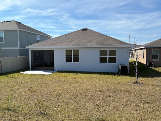 back of house with a patio, a yard, and central air condition unit