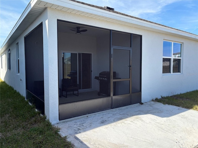 rear view of property featuring a sunroom