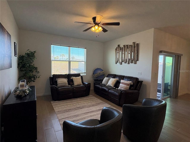 living room with wood-type flooring and ceiling fan