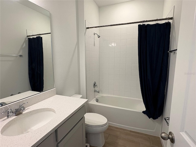 full bathroom with shower / bath combo, vanity, and toilet