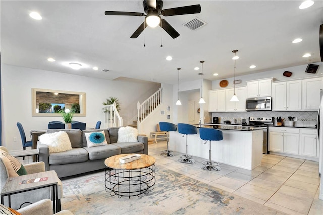 tiled living room featuring ceiling fan