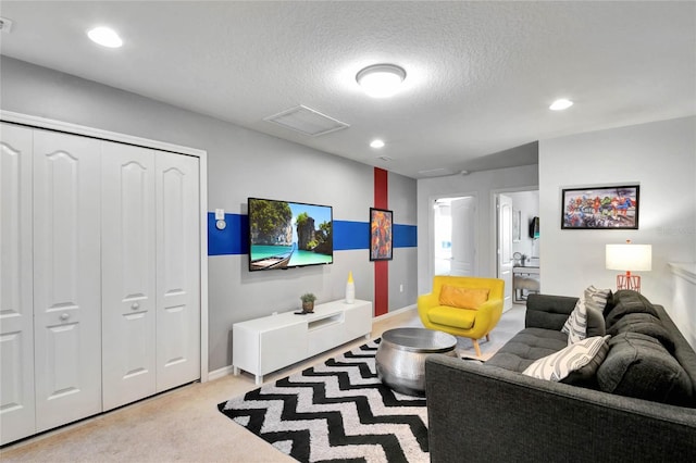 living room with light carpet and a textured ceiling