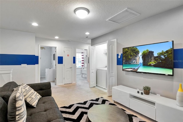 carpeted living room featuring a textured ceiling