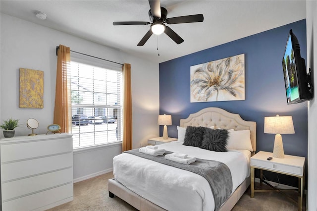 bedroom featuring light carpet and ceiling fan