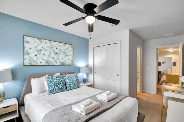 carpeted bedroom with a closet and ceiling fan