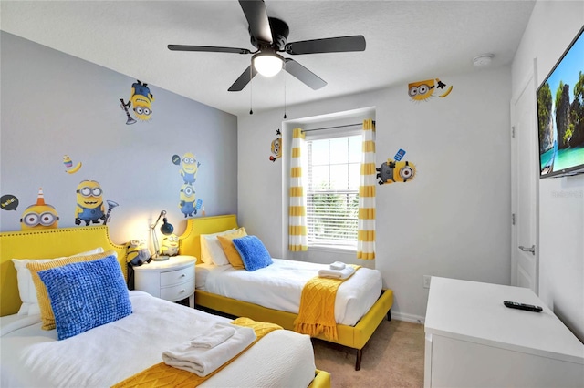 carpeted bedroom with a textured ceiling and ceiling fan