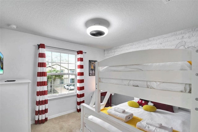 carpeted bedroom featuring a textured ceiling