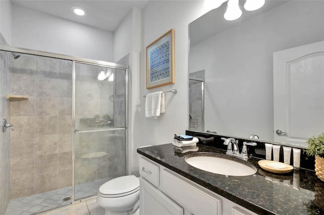 bathroom with walk in shower, vanity, toilet, and tile patterned flooring