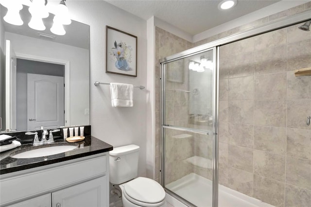 bathroom with vanity, toilet, and walk in shower