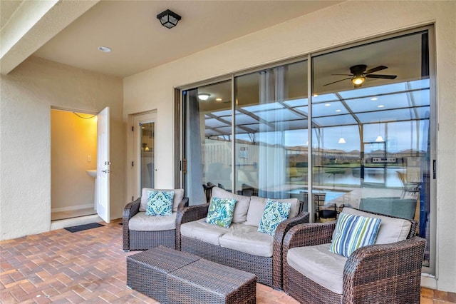 view of patio featuring a lanai, an outdoor hangout area, and a water view