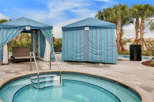 view of pool with an in ground hot tub and a patio area