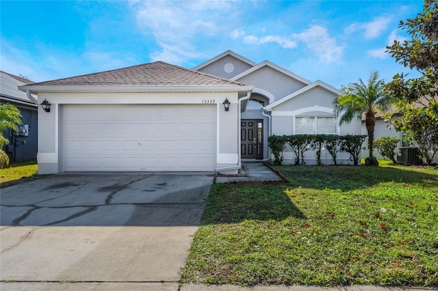 ranch-style house featuring central AC unit, a garage, and a front yard